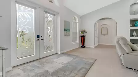 Bright entrance area of Villa Lavinia with decorative glass doors and stylish decor