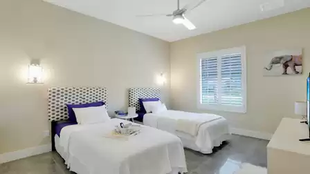 Guest room with two single beds, stylish headboards, and wall decoration.