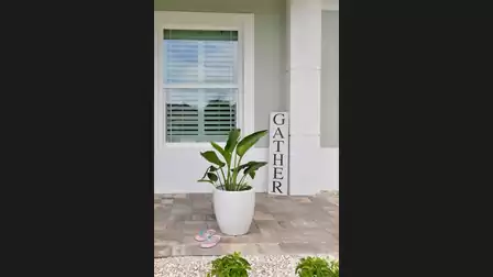 Close-up of the entrance area of Villa Cupido with a potted plant, decorative