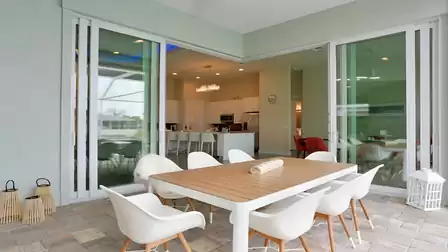 Terrace with a view into the modern, open kitchen.