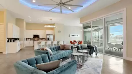 Bright living area with elegant decor, comfortable seating, and large sliding glass doors leading to the terrace.
