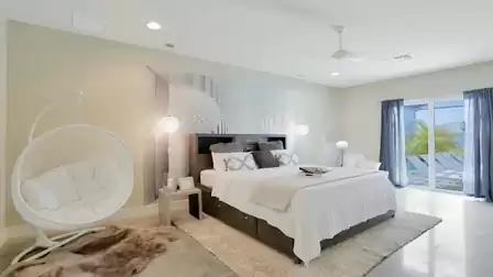 Spacious master bedroom with a comfortable king-size bed and stylish decor.