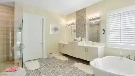 Luxurious bathroom with double vanity, freestanding bathtub, and large shower.