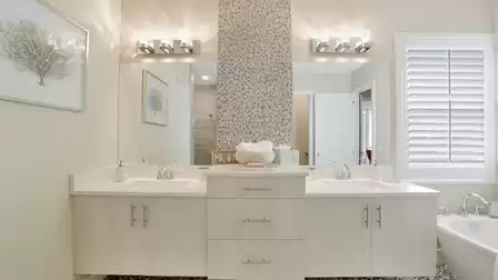 Modern bathroom with double sinks and stylish wall decoration.