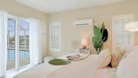 Guest suite: Bright bedroom with direct access to the pool area and tropical decor.