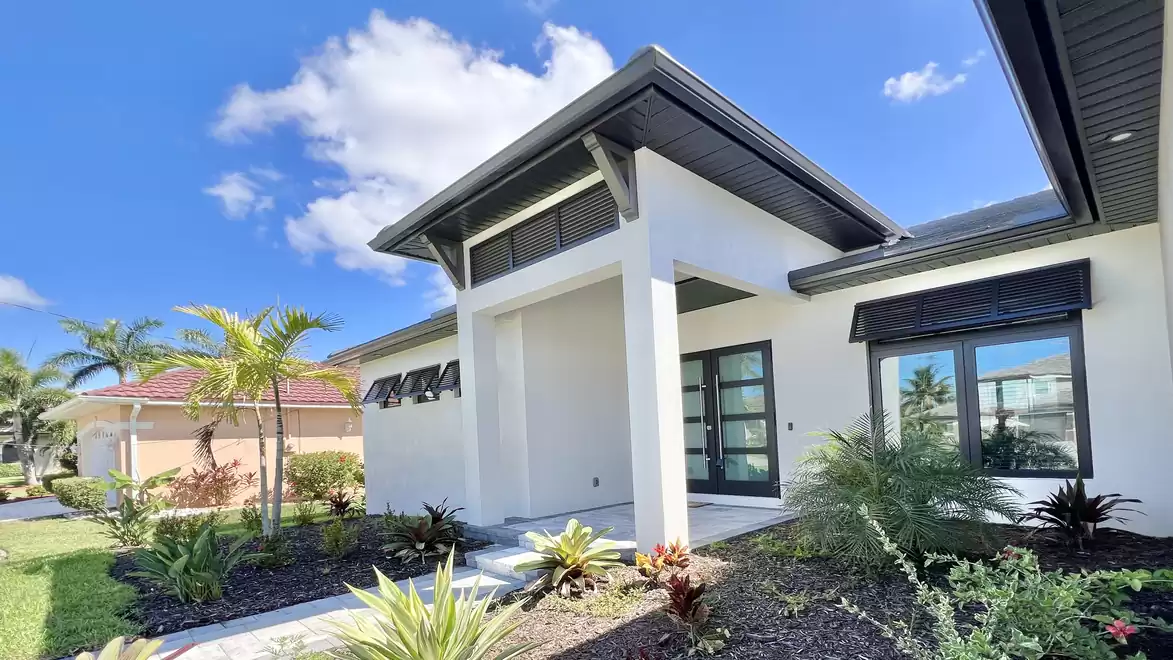 Close-up view of Villa Aldiana’s entrance featuring modern architecture and well-maintained tropical landscaping