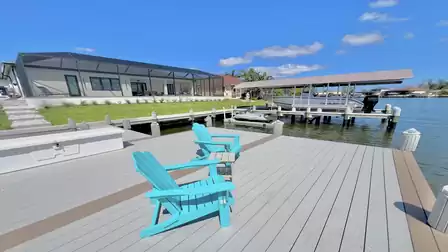 Spacious boat dock with seating area - perfect for relaxing right by the water.