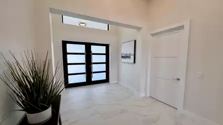 Bright entrance area with modern glass doors and stylish decor.