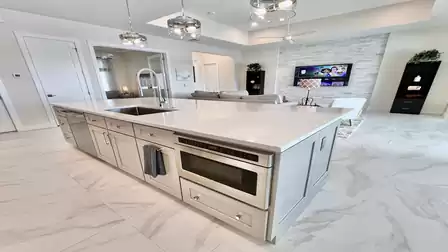 Stylish kitchen island with built-in microwave, sink, and ample storage - ideal for social cooking moments.