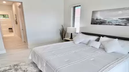 The primary bedroom offers direct access to the en-suite bathroom - perfect for a relaxed and stylish start to the day.