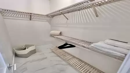 Walk-in closet with ample storage and convenient shelving.