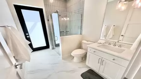 Bright bathroom with shower and direct terrace access - ideal after sunbathing.