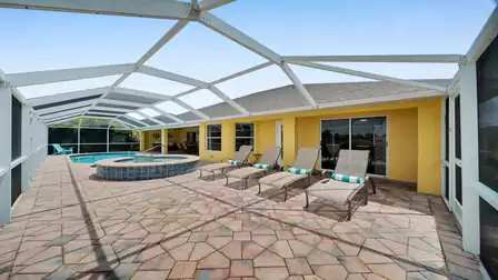 Spacious pool area with sun loungers - ideal for sunbathing and relaxing on vacation.