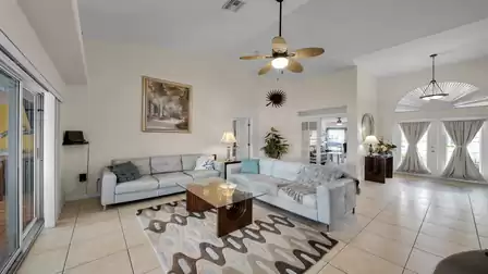 Spacious living room with high ceilings, plenty of natural light, and stylish connection to the entrance area and other rooms.
