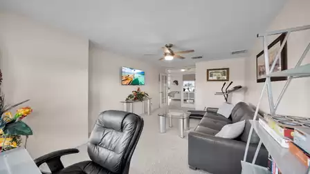 Multifunctional room with fitness equipment, desk, TV - well thought-out design for flexible use.