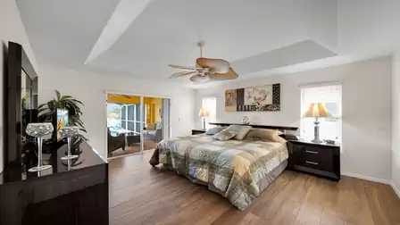 Master bedroom with king-size bed and direct access to the terrace and pool