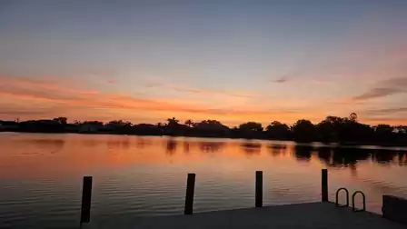 Atmospheric dusk on the lake with jetty - a dreamlike backdrop for daydreaming