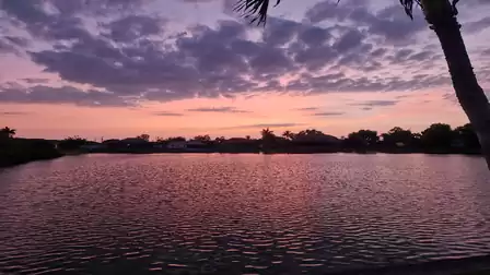 Romantic evening sky in pink and purple hues over the water – atmospheric dusk at the villa Casa de la  Vista