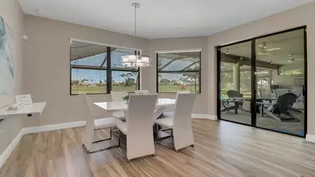 The bright dining area with a view of the terrace and golf course