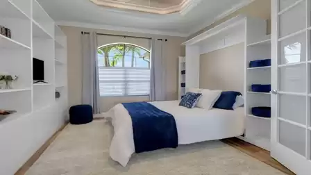 Murphy bed in one of the bedrooms in stylish blue and white