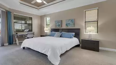 The master bedroom impresses with elegant furniture and a desk with a view