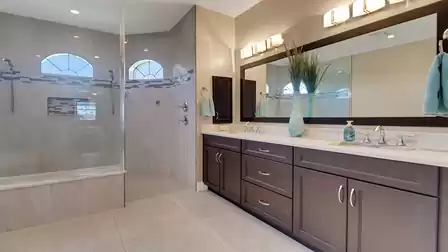 The bright master bathroom offers a luxurious walk-in shower and a double sink - ideal for relaxed morning routines for two.