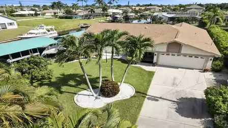 Villa Love Bird in Cape Coral features a well-kept garden, tropical palm trees, and direct canal access - perfect for boat trips from your private lift