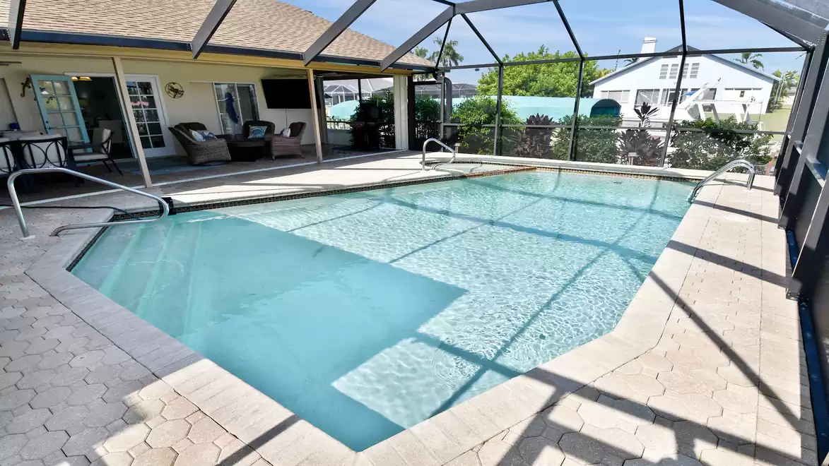 Screened pool area with plenty of space to relax - perfect for swimming fun in any weather.