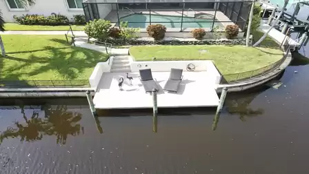 Two loungers, decorative bird sculptures and a direct view of the water create a charming little deck.
