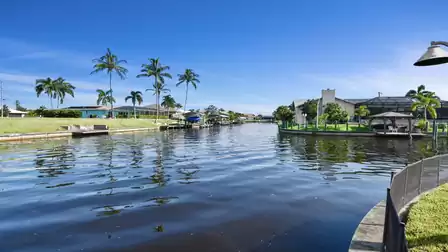 Canal view with palm trees and bright blue skies. The laid-back Florida lifestyle is right at your feet.