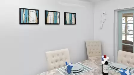 Modern wall art in turquoise and gold and a beautifully set table add color and elegance to the room.
