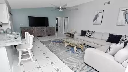 Modern living room with large sofa, stylish rug and carved wooden TV console