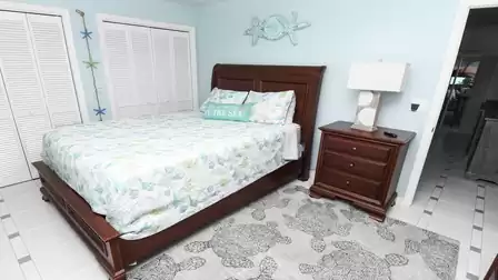 Maritime bedroom with queen size bed in soft colors and loving details