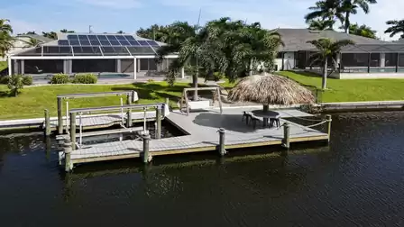 Large boat dock with lift and tiki hat and seating on the canal - ideal for ending the day with a sundowner or a glass of wine