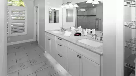 Almost all-white master bathroom with double sink and separate WC