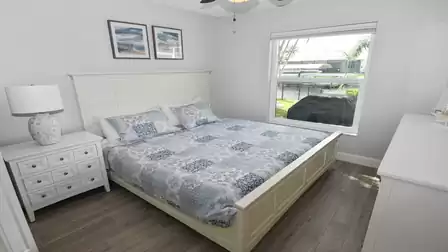 Cozy bedroom decorated entirely in blue and white, with King-Size bed for a restful night's sleep.