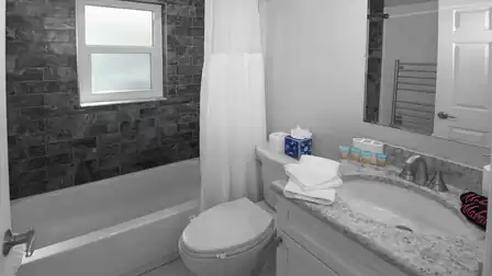 The second bathroom has a bathtub/shower combination, sink and WC