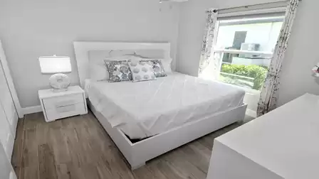 The third bedroom is almost entirely white and maritime decorations provide a stylish contrast