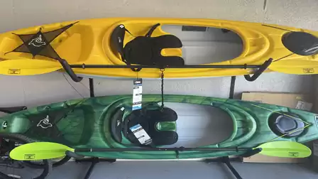 Two kayaks with paddles ready for relaxing trips on the canals of Cape Coral, Florida.