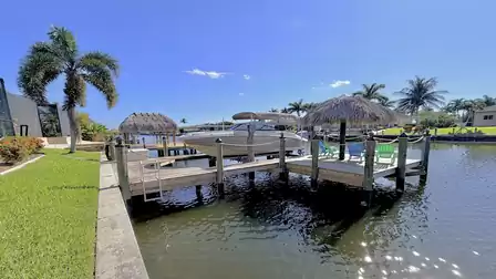 Private boat dock, sun deck and tiki hut directly on the canal, perfect for relaxing waterfront moments.