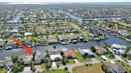 Aerial view of Villa Preziosa in Cape Coral, highlighted on the canal with direct waterfront location.