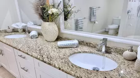 Modern bathroom with double sink, granite countertop, and plenty of storage space for your cosmetics Modern bathroom with double vanity, granite countertop and generous counter space.