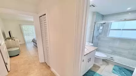 Hallway area with access to another bedroom and view into the bathroom