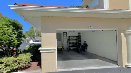 Private condo garage with parking space and storage area