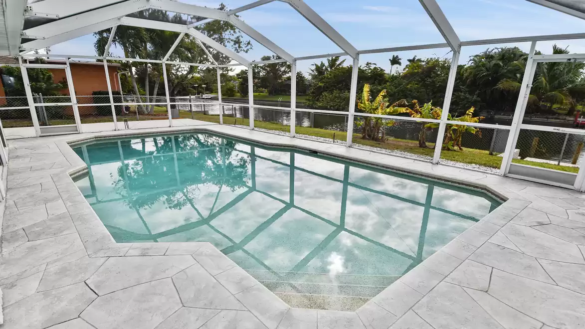 Screened pool area with water view, perfect for relaxing swim days in a quiet private setting