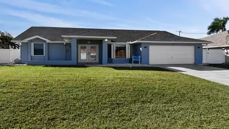 Villa Talita vacation villa in Cape Coral with well-kept garden, modern facade, and garage