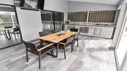 Large covered terrace with outdoor kitchen and dining area invites you to enjoy meals together 