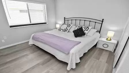 Attractive black and white combinations in the third bedroom with an oversized double bed