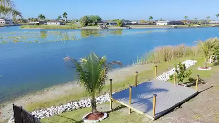 Private dock directly on the lakeshore with beautiful views across the water and surrounding palm landscape - a perfect spot to relax and enjoy the peaceful atmosphere.