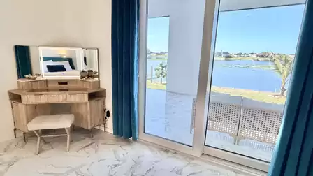 Vanity table by the window with beautiful lake views and direct access to the covered waterfront terrace.